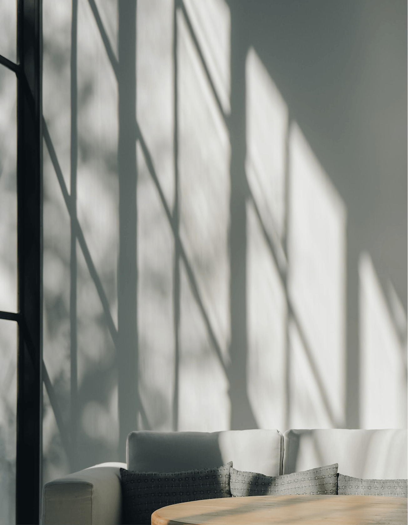 Window shadows falling across a quiet interior.